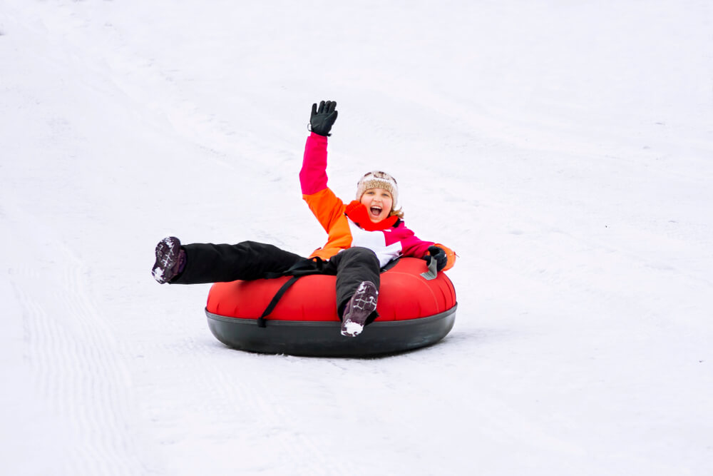 A person snowtubing on a Gatlinburg winter vacation.